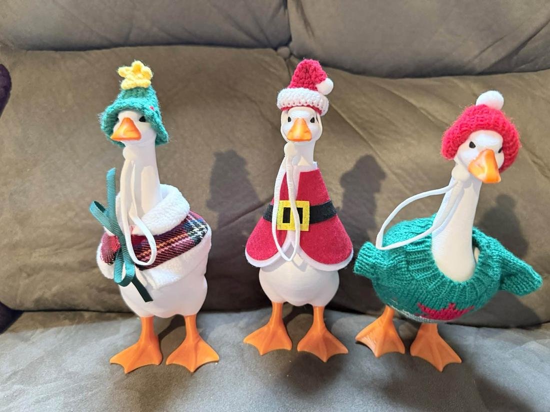 Three desk geese in Christmas outfits
