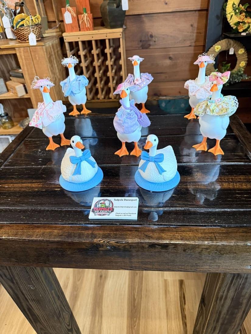 Desk geese in hats and bows at a market booth