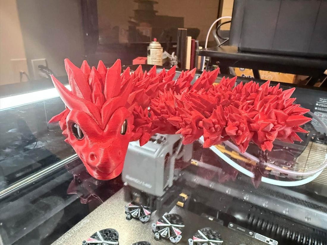 Red articulated dragon fresh off the 3D printer